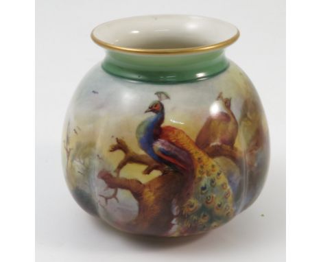 A Royal Worcester quarter lobed vase, decorated with peacocks and pine cones in a landscape, by F J Bray, to a green ground n