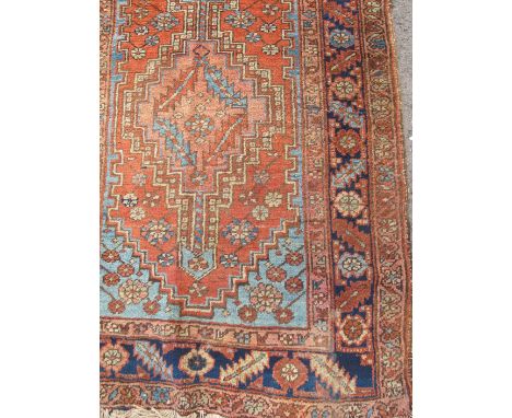 An Eastern runner, with leaf and diamond decoration to the field to a leaf and flower head border, 73ins x 39ins 