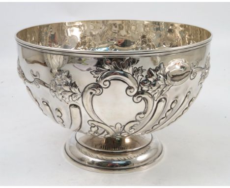 A 19th century silver pedestal bowl, with ribbed edge, embossed decoration of flowers and gadrooned, raised on a circular ped
