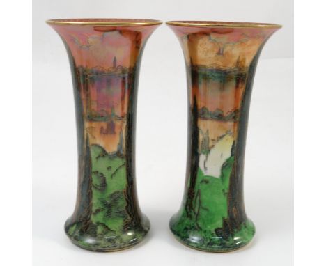 A pair of Royal Worcester Crown Ware lustre vases, of trumpet shape, decorated with Continental landscapes of trees with buil