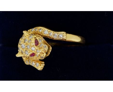 An 18 carat gold diamond leopard ring with ruby eyes, size K 