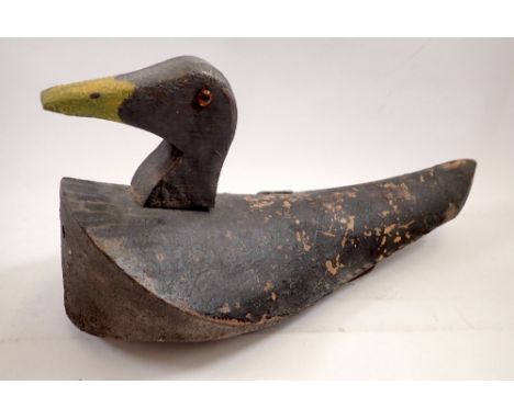 A vintage American wooden decoy duck painted black, 41cm long 