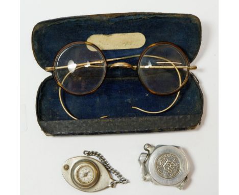 A pair of tortoiseshell spectacles cased, a coin cigarette lighter and compass fob 