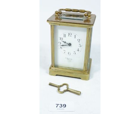 A brass cased French carriage clock with key 
