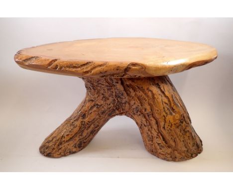 A rustic wooden occasional table on trunk supports, 32cm tall 