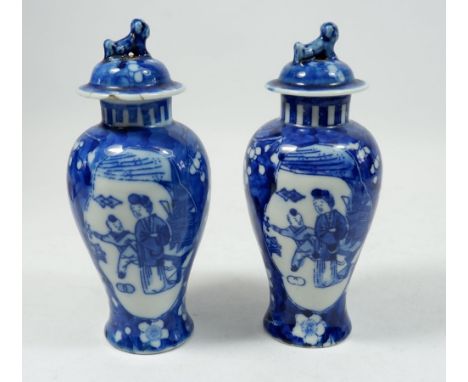 A pair of Meiping blue and white vases with lids, base mark 'Kangxi Nianzhi', 17cm tall 