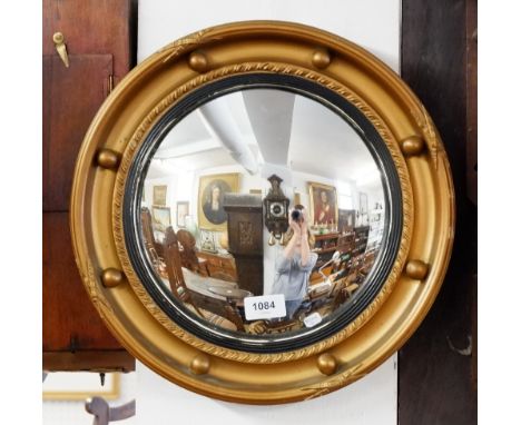 A circular gilt framed mirror with ball surround, 36cm diameter 