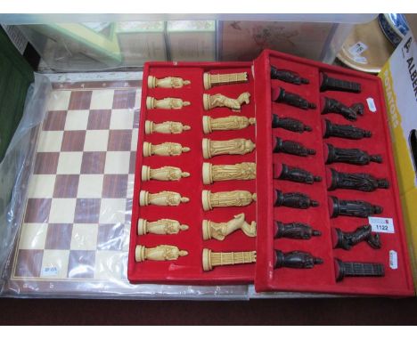 A chess set complete with board and resin pieces in fitted boxes. (3)