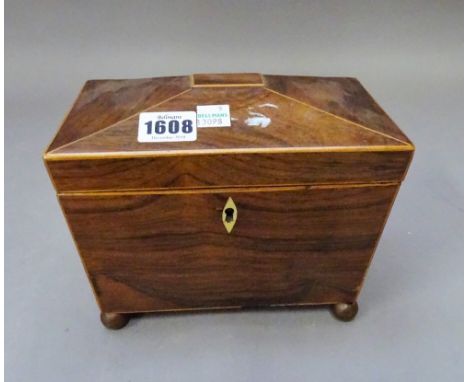 A Regency rosewood sarcophagus tea caddy on gilt ball feet, 20cm wide x 15cm high x 12cm deep.  