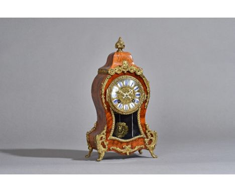 A French Louis XVI style walnut cased mantel clock, circa 1900, with waisted cased and gilt metal foliate embellishments, ena