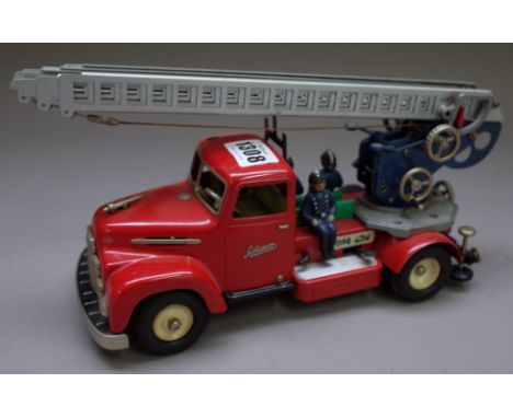 A Schuco fire engine, red, with four part extending ladder and three composition figures, registration N0080. (a.f.)