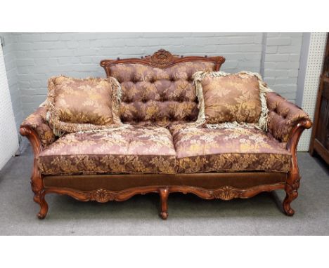 A 20th century hardwood framed sofa on six scroll supports, 205cm wide x 108cm high. 