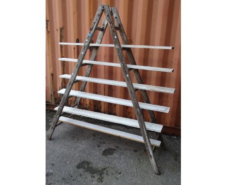An early 20th century pine seven rung ladder, 200cm high. 