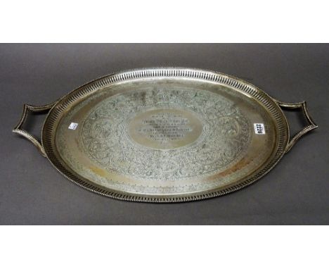 A Victorian silver twin handled oval tray, presentation inscribed to the centre within an engraved surround with a pierced bo