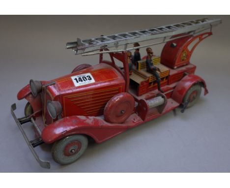 A French tinplate fire engine by Unis of France, pre-war, with mechanical movement, indistinct stamp, 41cm wide (a.f).  