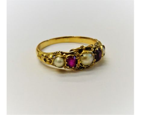 A gold, ruby and cultured pearl ring, mounted with two cushion shaped rubies, alternating with three cultured pearls, the mou