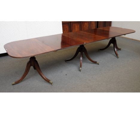 A Regency style mahogany triple pillar extending dining table on ten downswept supports, two extra leaves 99cm wide x 215cm l