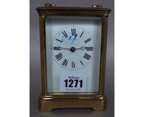 A French brass cased carriage clock, early 20th century, with visible platform escapement, white enamel dial and a two train 