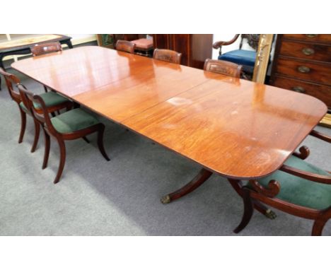 A George III style mahogany twin pillar extending dining table, on six downswept supports, with a pair of extra leaves, 114cm