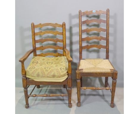 A set of six early 20th century oak ladder back dining chairs with rush seats, to include one carver, (6). 