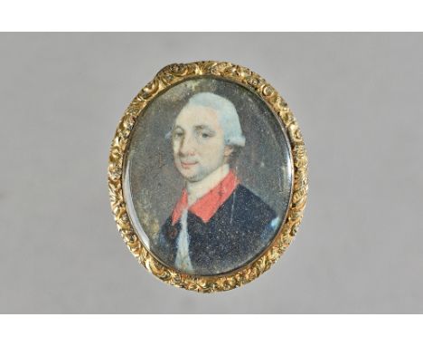An oval portrait miniature of a gentleman, with grey hair, his coat having a red collar, mounted as a pendant, probably first