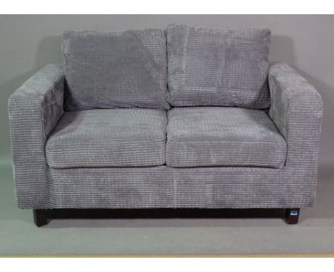 A 20th century small two seater grey upholstered sofa on block supports, 140cm wide. 