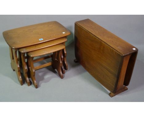 Ercol; a 20th century oak nest of tables, 57cm wide x 42cm high and a pair of white painted tripod tables, 46cm wide x 62cm h