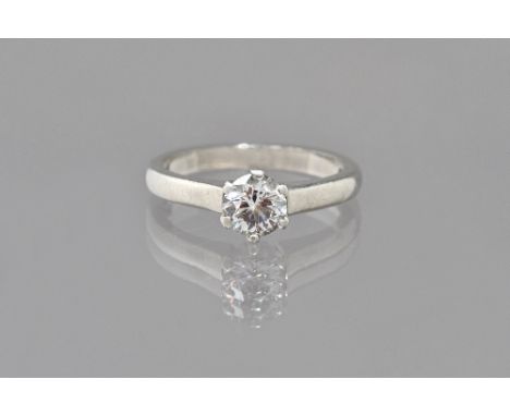 A platinum and diamond single stone ring, claw set with a circular cut diamond, the diamond weighs approximately 0.60 cts, ri