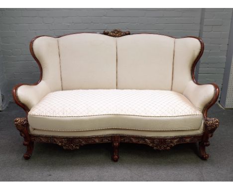 A 20th century parcel gilt hardwood framed shaped sofa on scroll supports, 182cm wide x 107cm high. 