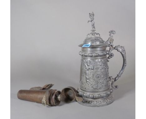 An early 20th century large pewter tankard with acanthus and cherub decoration, 39cm high, two hunting whips and a 20th centu