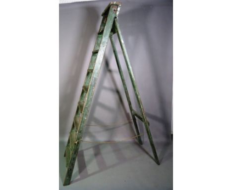 An early 20th century green painted eight rung 'A' frame ladder, 210cm high. 