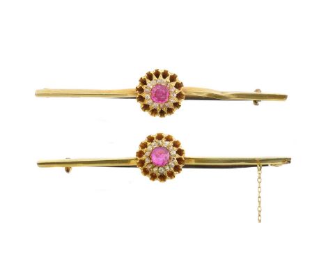A pair of ruby and diamond brooches, each designed as a cushion shape ruby within an old cut diamond surround, with polished 