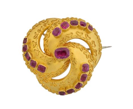 A Victorian ruby brooch, of rounded form, with cushion shape sapphire graduated lines and cannetille detailing, may also be w