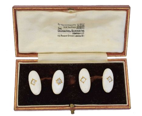A pair of French 18ct gold enamel and diamond cufflinks, each designed a pair of oval shape textured white enamel panels set 