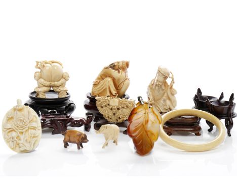 THREE EARLY 20TH CENTURY CHINESE IVORY FIGURESalong with handwood stands, ivory bangle, ivory pendant, jade pendant, and two 