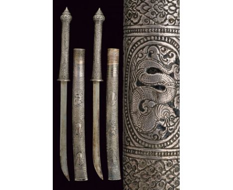 A pair of silver mounted Dha, dating: 19th Century, provenance: Burma, dating: 19th Century, provenance: Burma, Simple, sligh