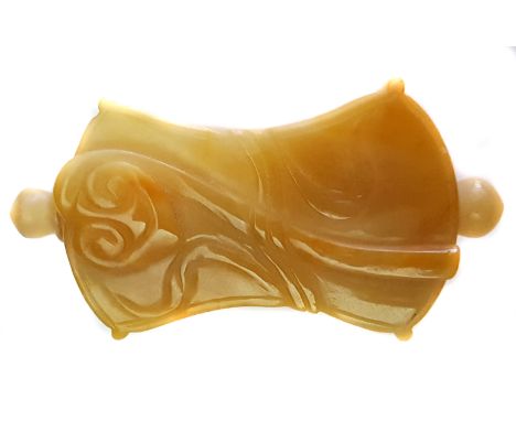 A carved yellow jade snuff bottle, carved with a lotus flower and a musical bamboo, waisted rectangular form with ball stoppe