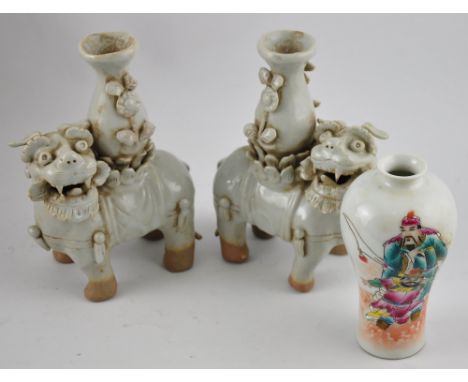 Two Chinese ceramic candlesticks in the form of beasts bearing vases, together with a Chinese vase