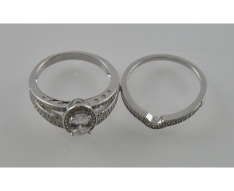 A silver and cubic zirconia dress ring and matching half eternity ring 