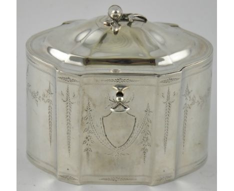 An 18th Century Continental silver tea caddy of panelled oval form, the domed hinge cover with cast acorn knop, enclosing a t