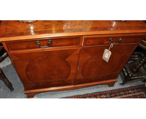 A reproduction yew small sideboard, fitted two drawers on splay bracket feet, w:104cm