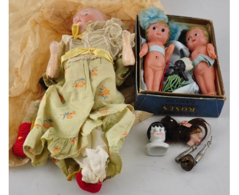 An early 20th Century German bisque doll together with two composition Kewpie type dolls etc