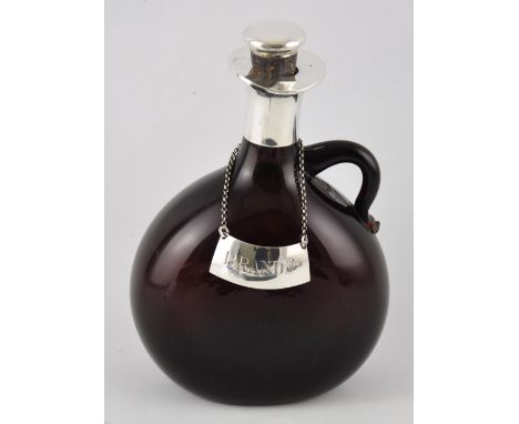 A Victorian silver mounted amber glass brandy flask with chain hung brandy label, all by George Betjamin, London 1871