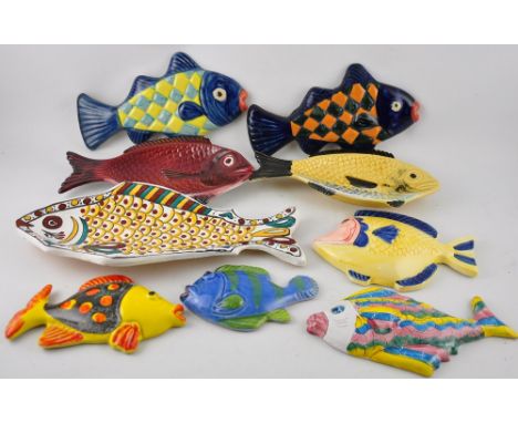 A collection of nine various glazed ceramic wall plaques modelled as fish. Largest: L. 34.5cm (8)