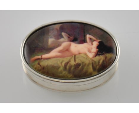 A silver pill box with enamel set nude to the lid