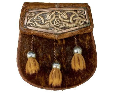 the flap applied with a white metal frieze of entwined dragons centred by Celtic knotwork, loose, three white metal and fur t