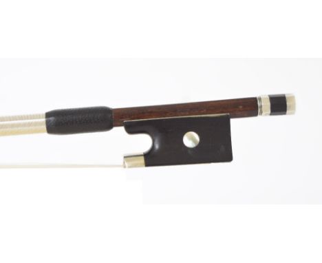 Violin bow stamped C. Bazin, the stick round, the ebony frog inlaid with pearl eyes and the ebony adjuster with two nickel ba