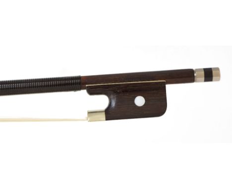 Silver mounted violin bow stamped Tourte, the stick octagonal, the ebony frog inlaid with pearl eyes and the ebony adjuster w