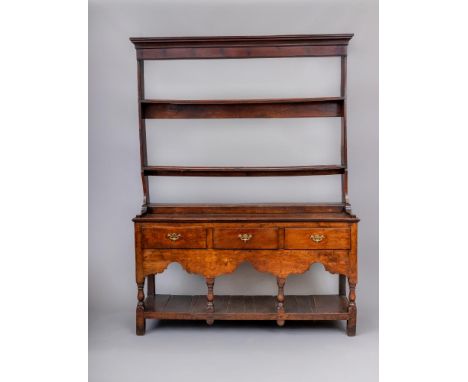 A GEORGIAN OAK POT BOARD DRESSER, late 18th century, the open back delft rack with cavetto moulded cornice over two shelves a