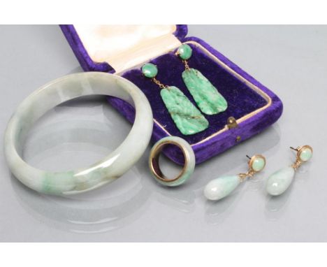 A PAIR OF CHINESE JADE(?) PENDANT EARRINGS, 1930's, screw action with button stud hung with a shaped oblong panel carved and 